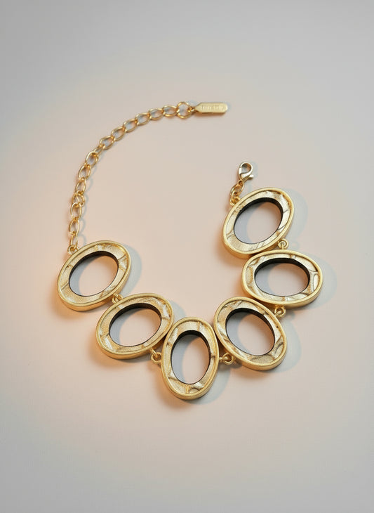 Gold leather bracelet, reversible with silver and gold textured leather, with gold plated casing