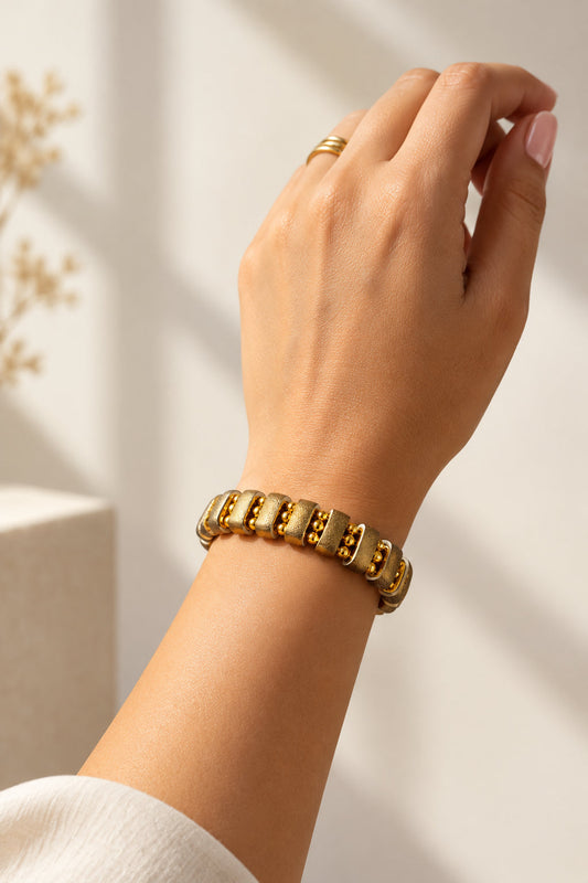Noupelle Sienna bracelet featuring 18K gold-plated brass and upcycled leather worn on a woman's wrist